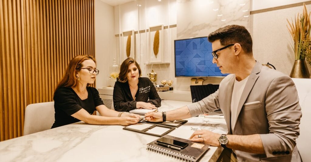 Professionals discussing documents at a table in a contemporary office.
