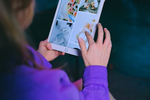 pexels-photo-7194759-7194759 A woman in a purple sweater browsing a digital photo album on a tablet indoors.