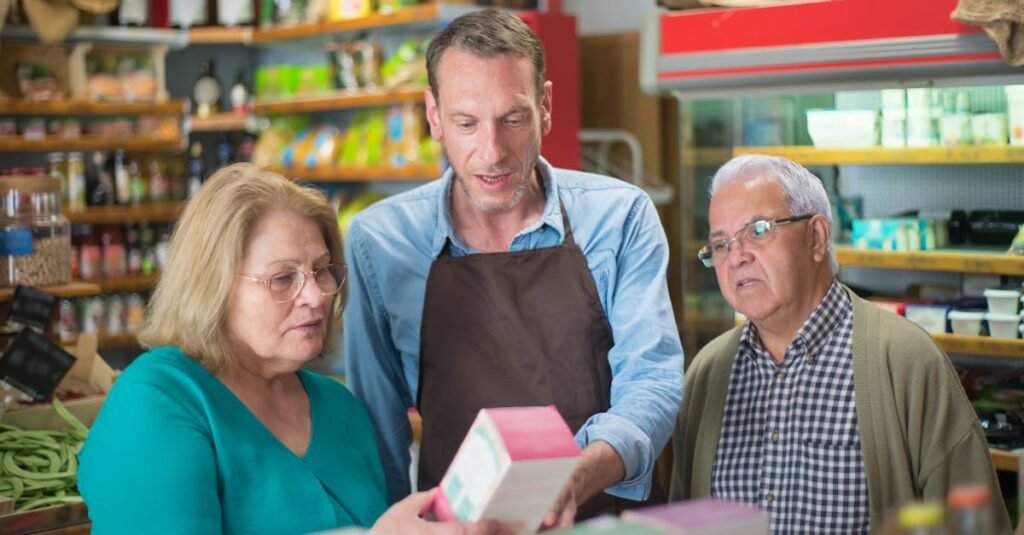 A shopkeeper assists elderly customers in a vibrant Portuguese grocery store.